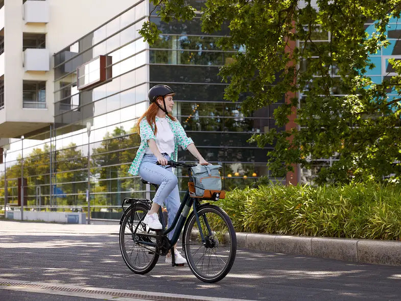 Woman riding a city bike in an urban environment.