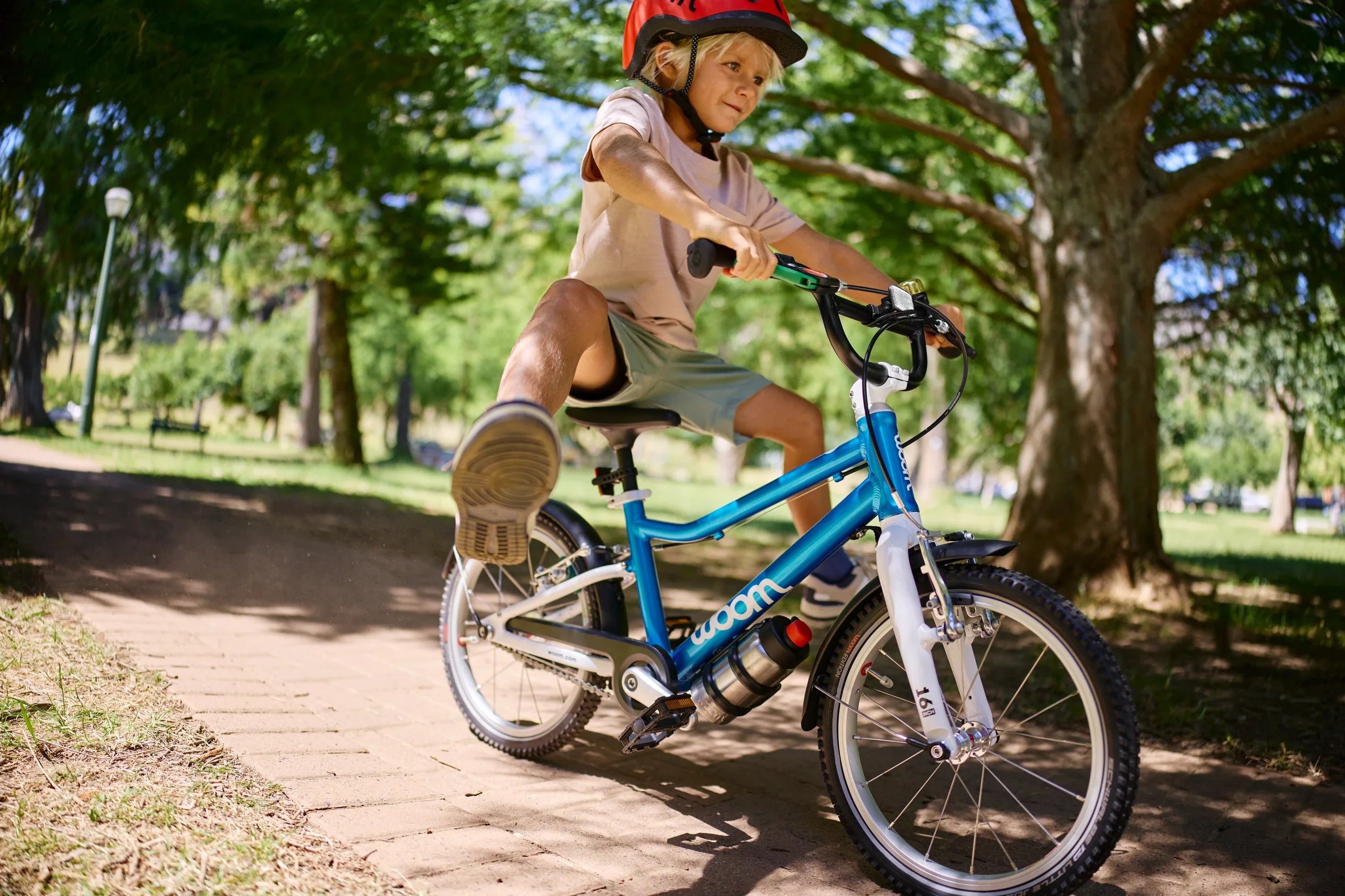 Young boy riding a bicycle.
