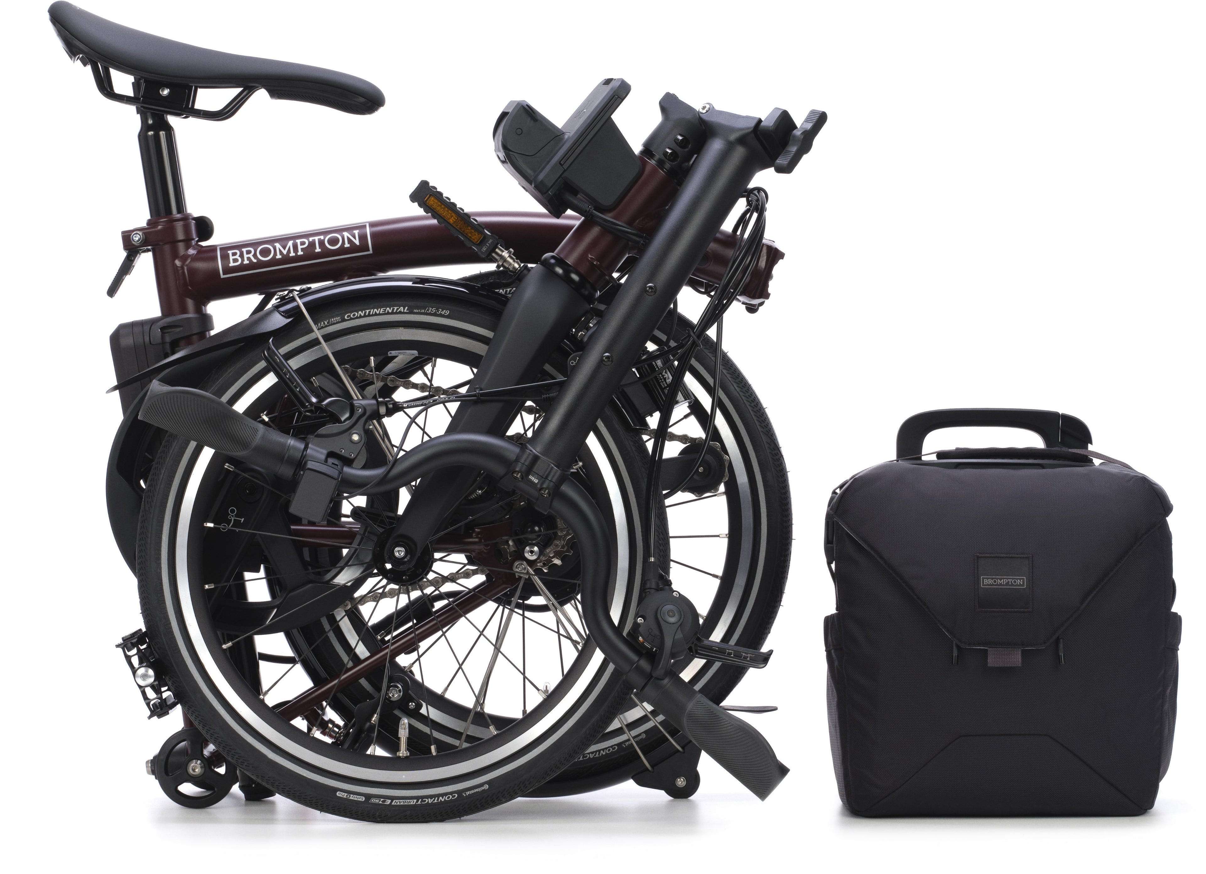 Brompton folding bicycle and black backpack on a white background
