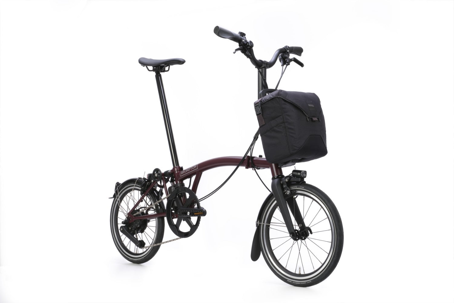 Brompton folding bicycle with a black bag on a white background