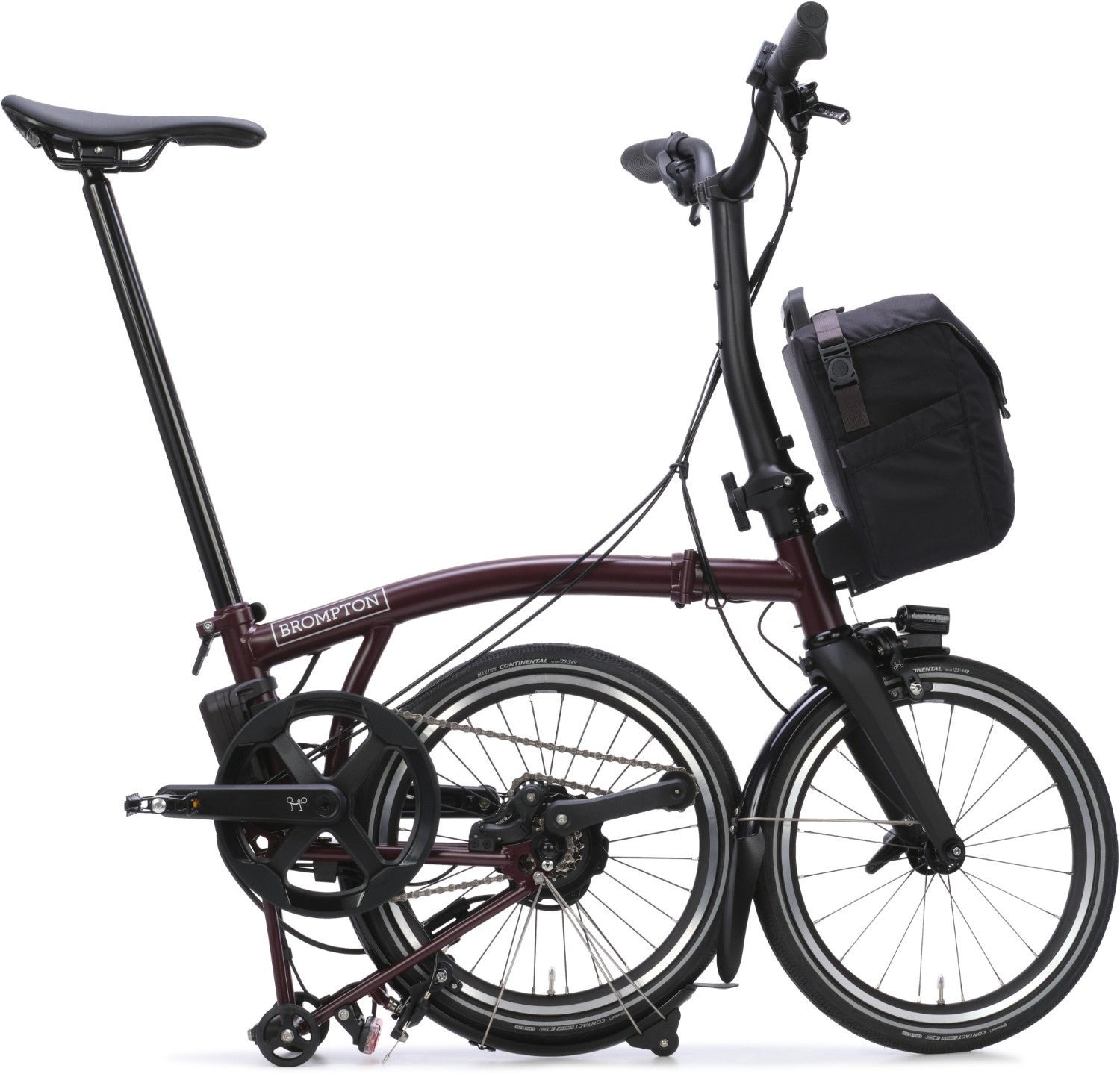 Brompton folding bicycle with a black bag on a white background