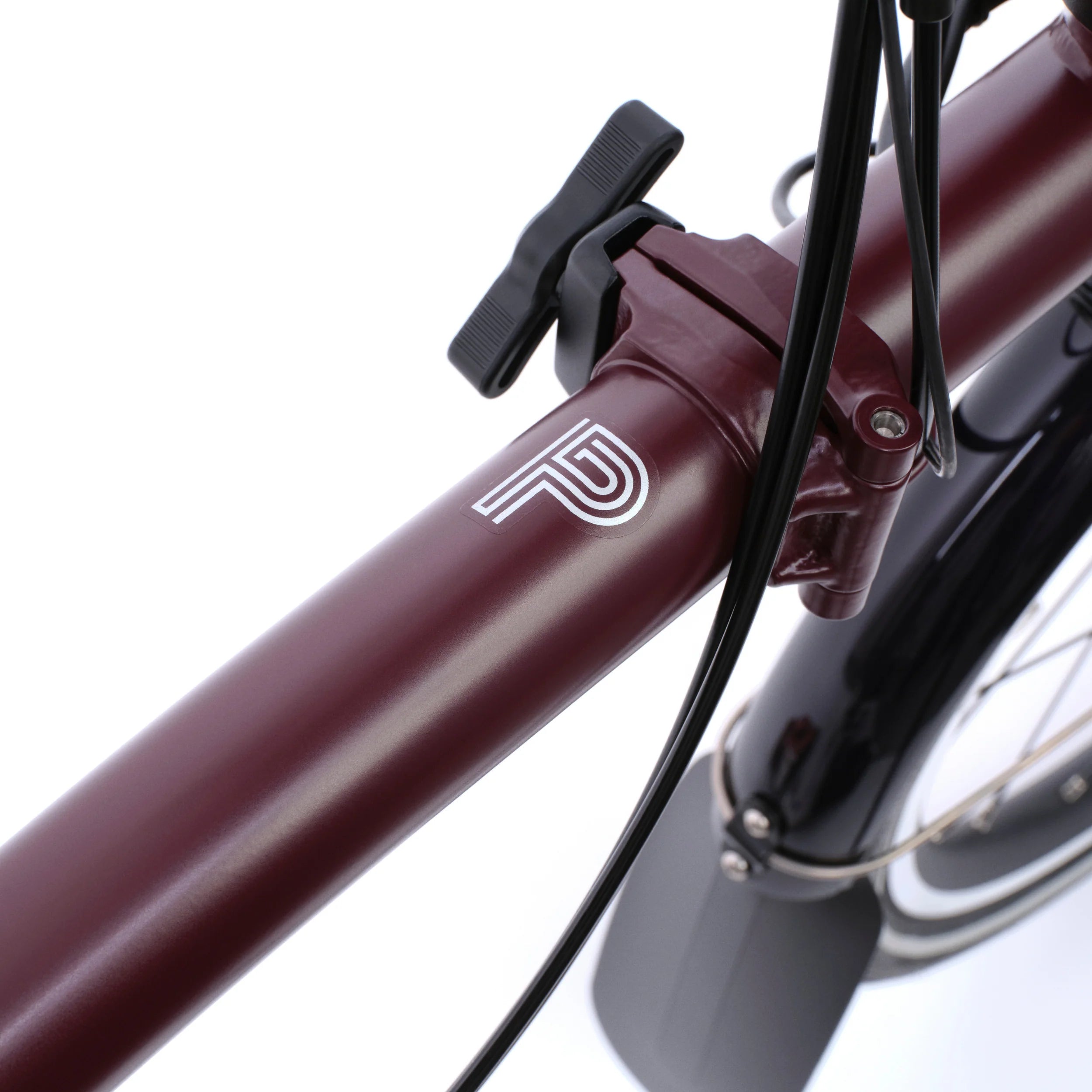 Close-up of a bicycle handlebar with a brand logo on a white background