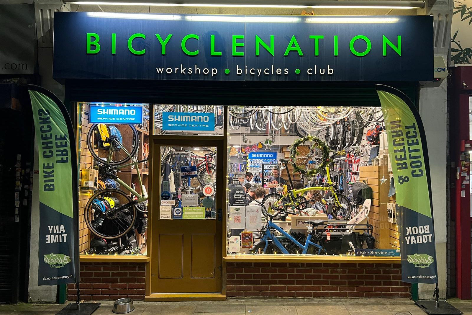 Bicycle shop named 'Bicyclenation' with bicycles on display inside.