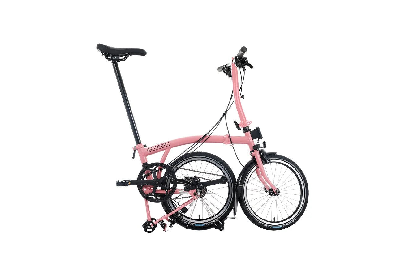 Pink folding bicycle on a white background