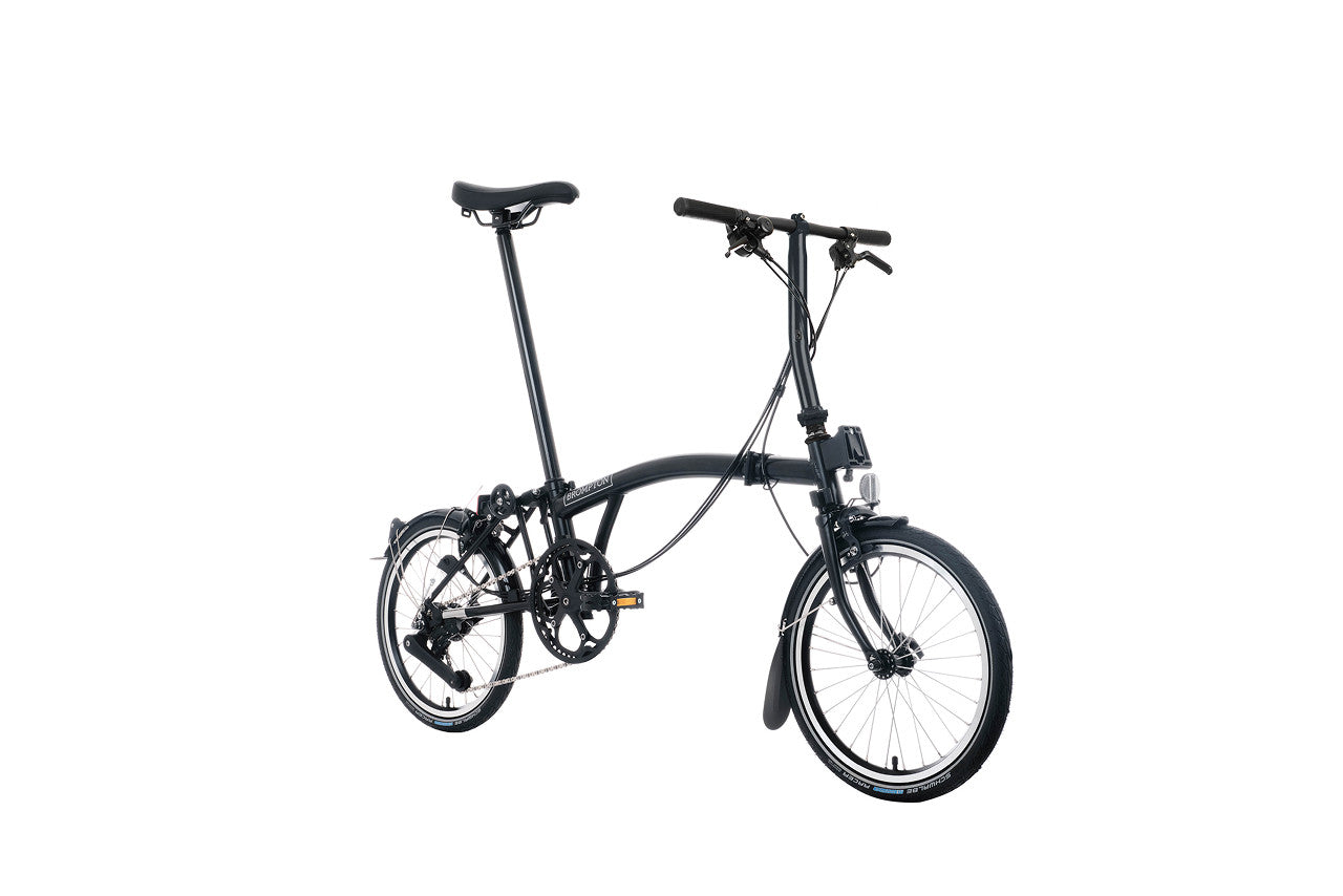 Brompton folding black bike on a white background.