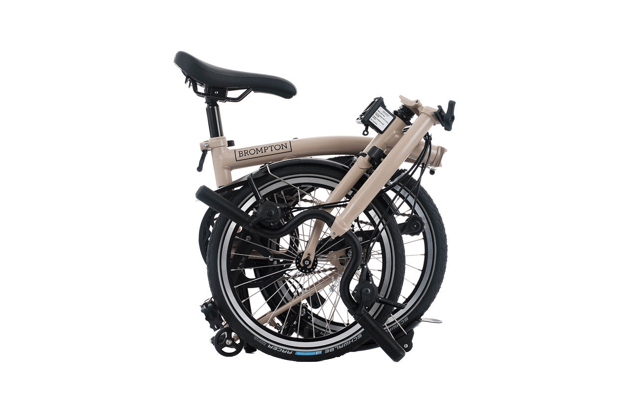 Foldable bicycle with 'Brompton' branding on a white background