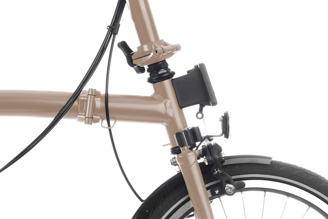 Close-up of a beige bicycle with a smartphone mount on a white background