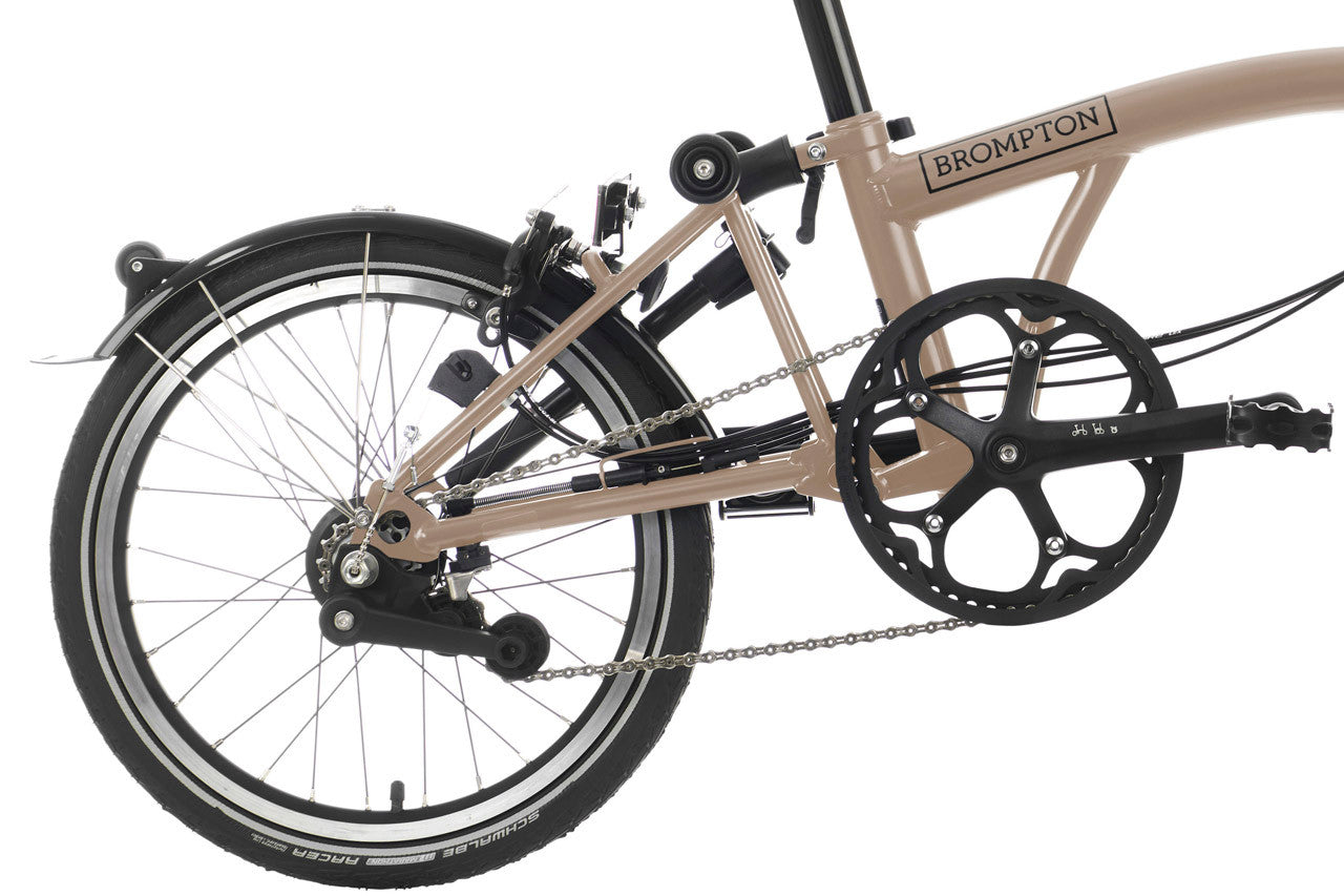 Close-up of a folded Brompton bicycle on a white background