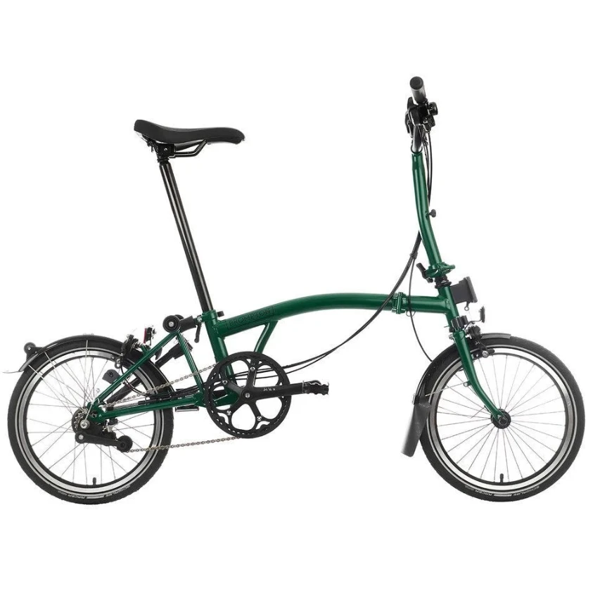 Green Brompton folding bike on the white background.