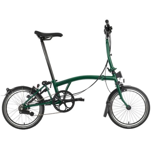 Green Brompton folding bike on the white background.