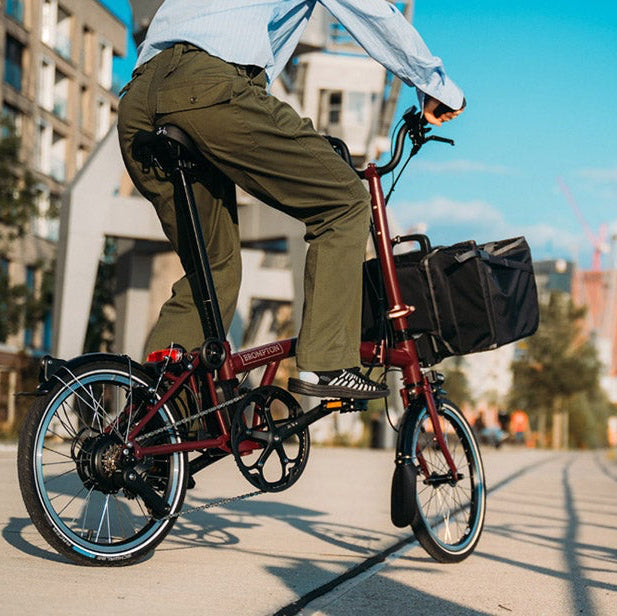 Person riding a bicycle with a basket on a city street