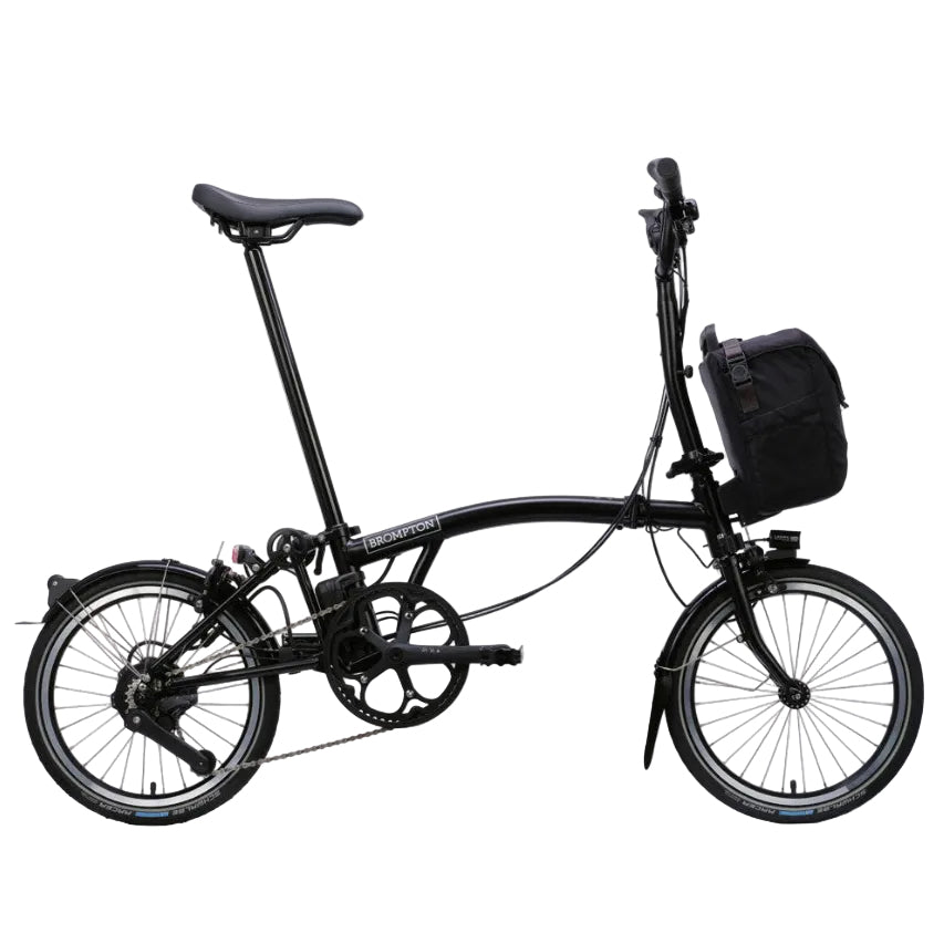 Black Brompton folding bicycle with a basket on a white background