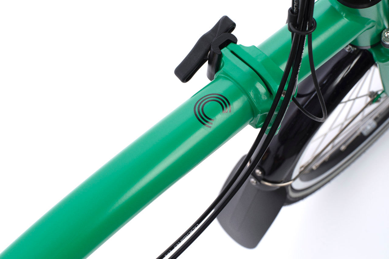 Close-up of a green bicycle frame with a white background