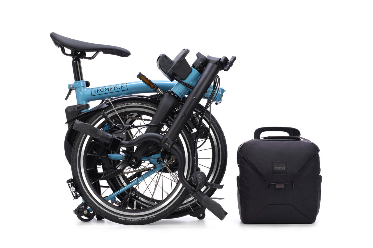 Folded bicycle with a black carrying case on a white background