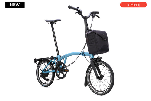 Blue electric bike with a black basket on a white background, featuring the brand 'e-Motiq'.