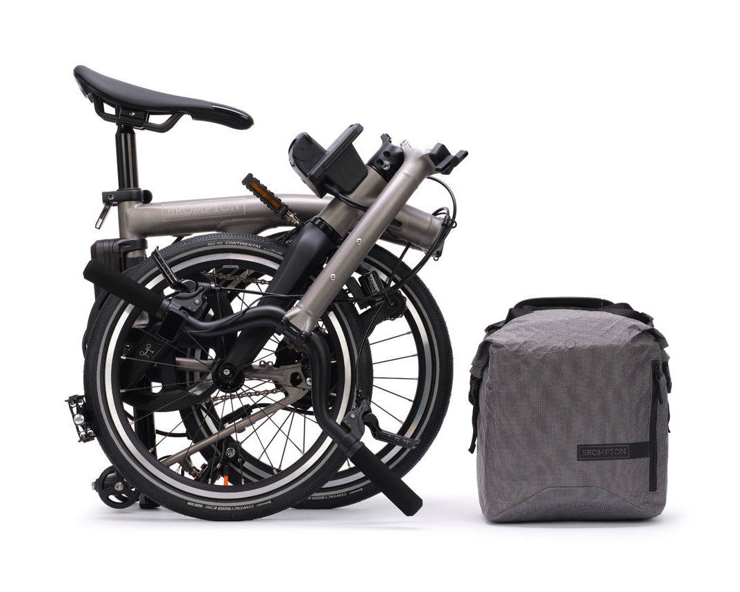 Folded bicycle with a gray bag on a white background