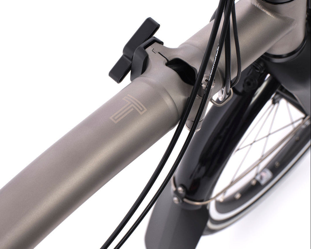 Close-up of a bicycle's handlebar and front wheel on a white background