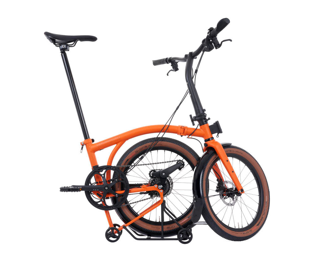 Orange and black Brompton G Line folding bicycle on a white background