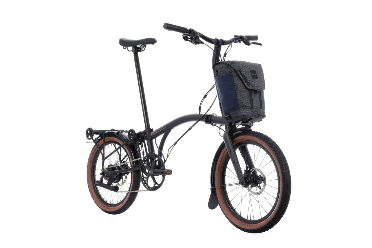 Brompton G Line Electric folding bike with grey bag on the white background.