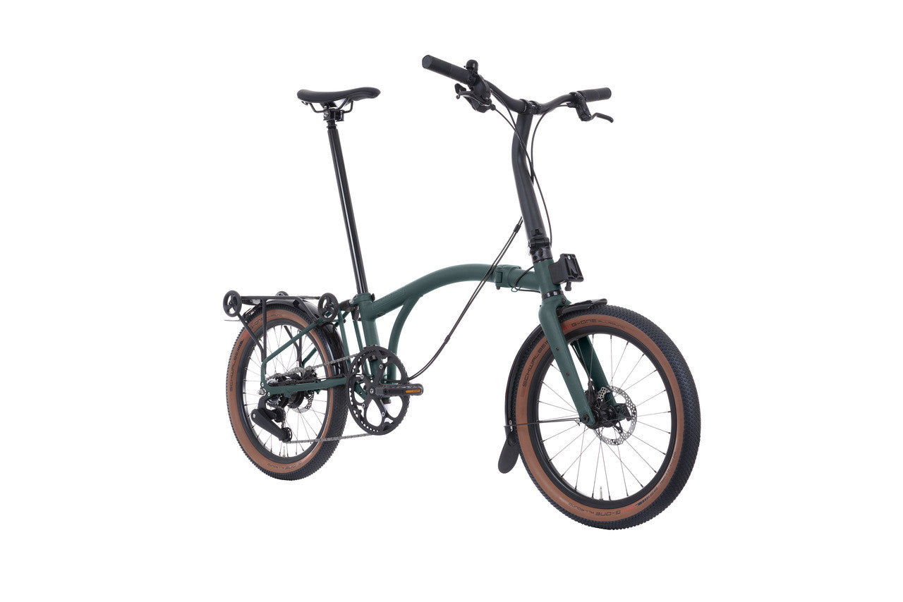 Green Brompton folding bicycle on a white background