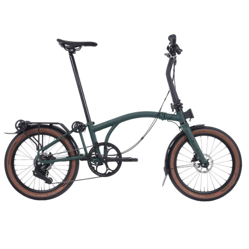 Green Brompton folding bicycle on a white background