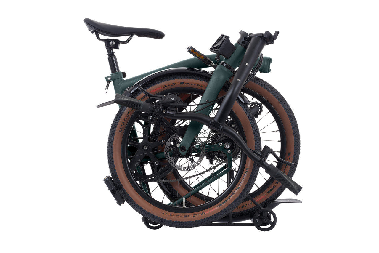 Folded Brompton bicycle on a white background