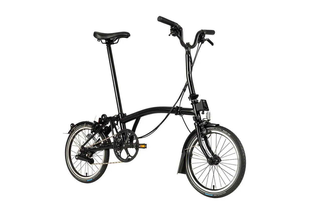 Black Brompton folding bike on the white background.