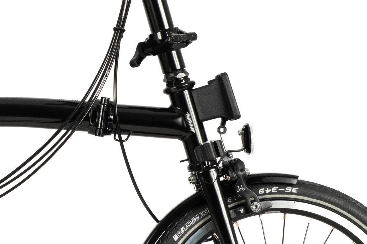 Black Brompton folding bike on the white background. The photo is showing a Brompton Lagguage block.