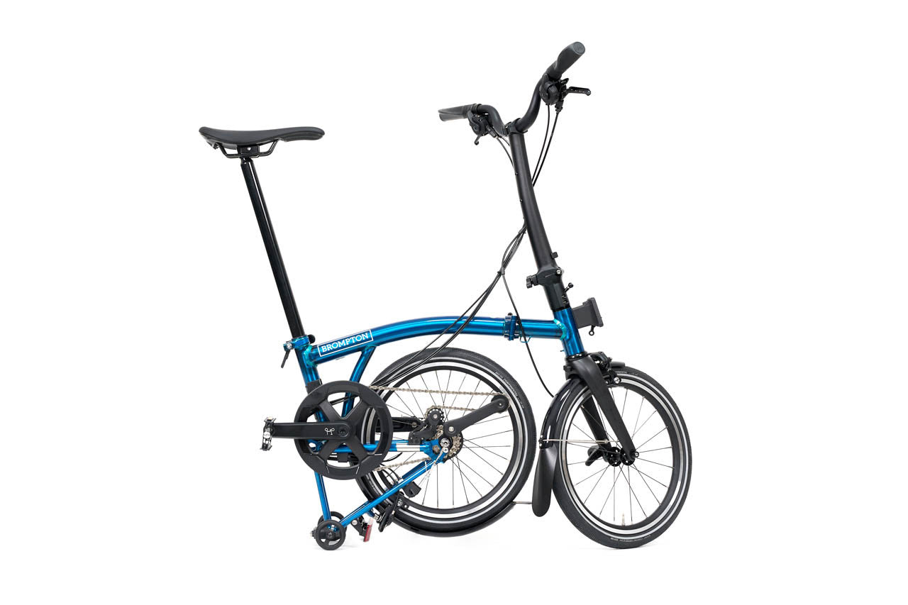 Blue brompton p line folding bicycle on a white background