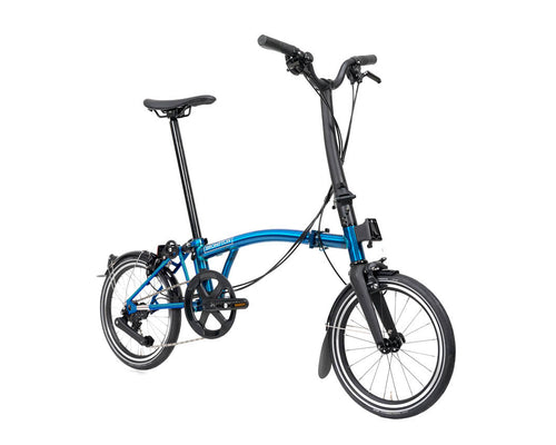 Blue brompton p line folding bicycle on a white backgorund