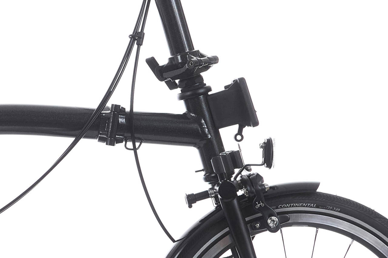 Close-up of a black bicycle frame with visible Continental tire on a white background