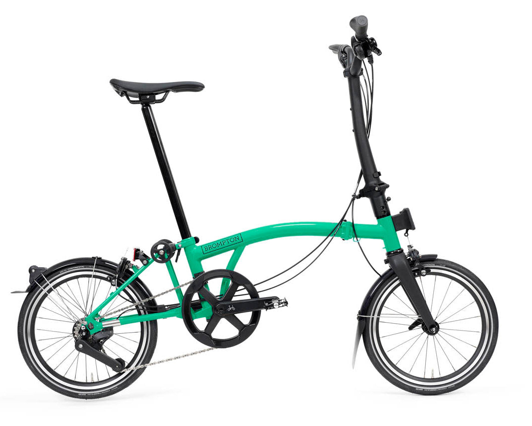 Green Brompton P Line folding bicycle on a white background