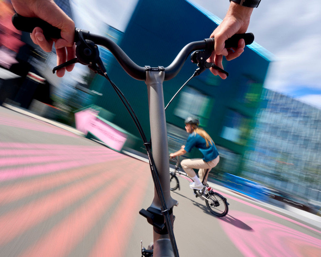Person riding a bicycle on a city street with blurred motion effect
