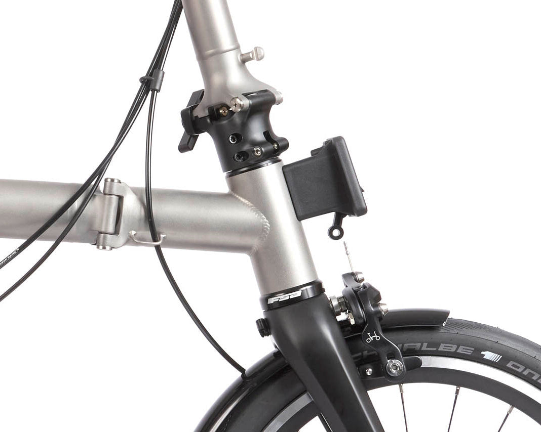 Close-up of a bicycle's handlebar and front wheel on a white background