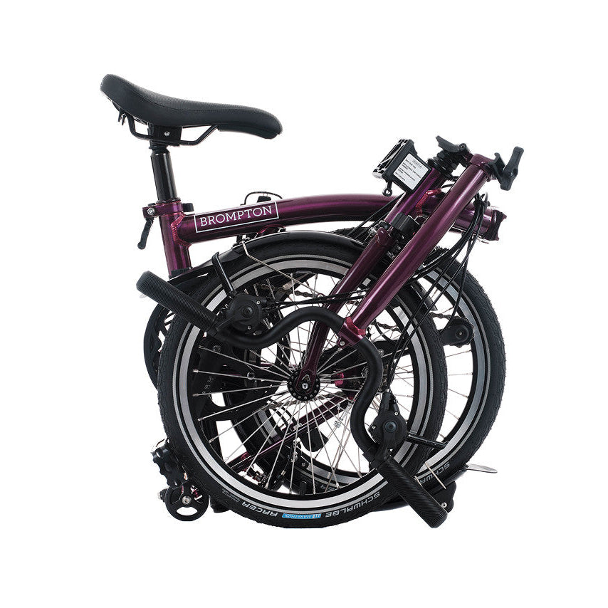 Folded bicycle with 'Brompton' branding on a white background