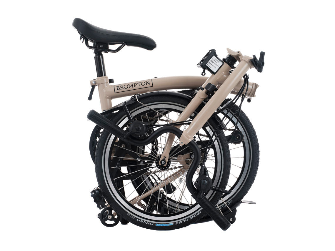 Foldable bicycle with 'Brompton' branding on a white background