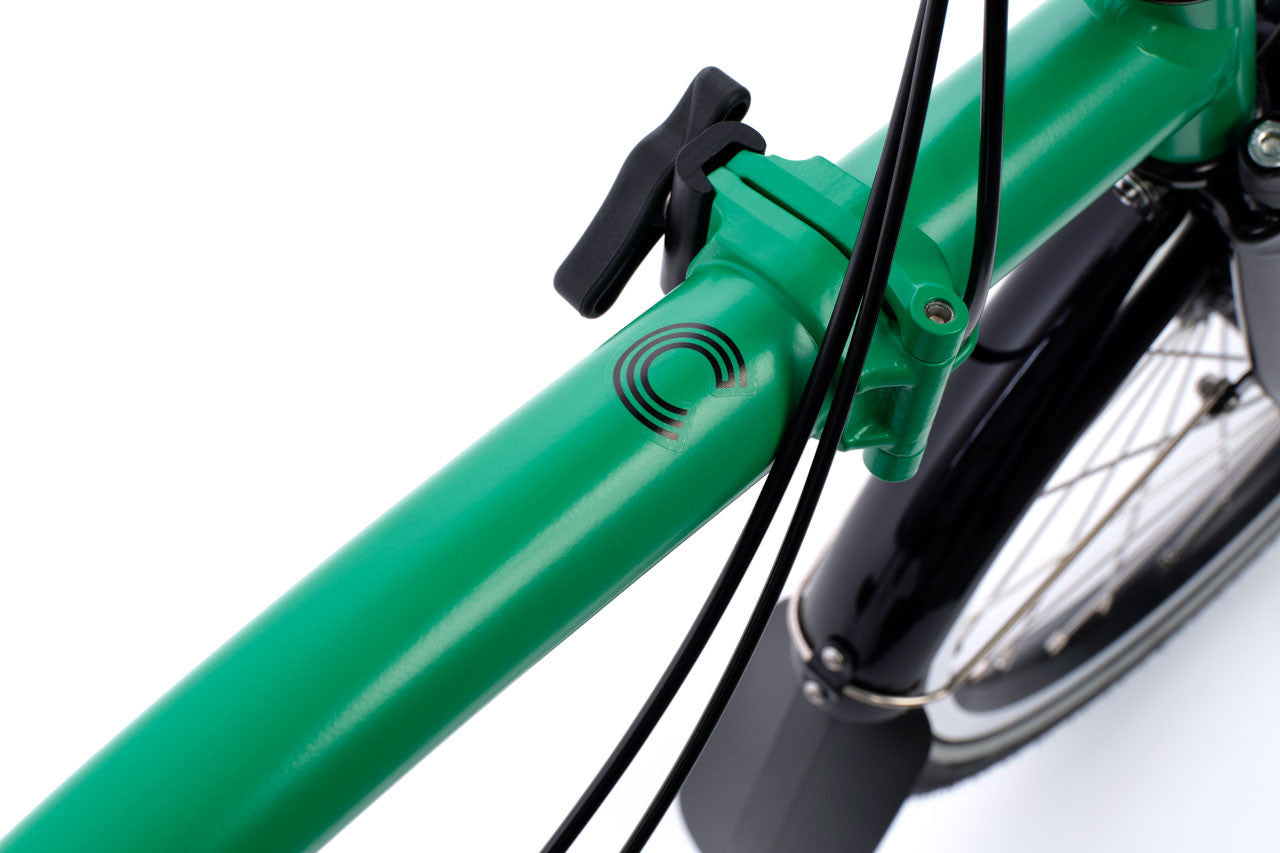 Close-up of a green bicycle frame with a logo on a white background