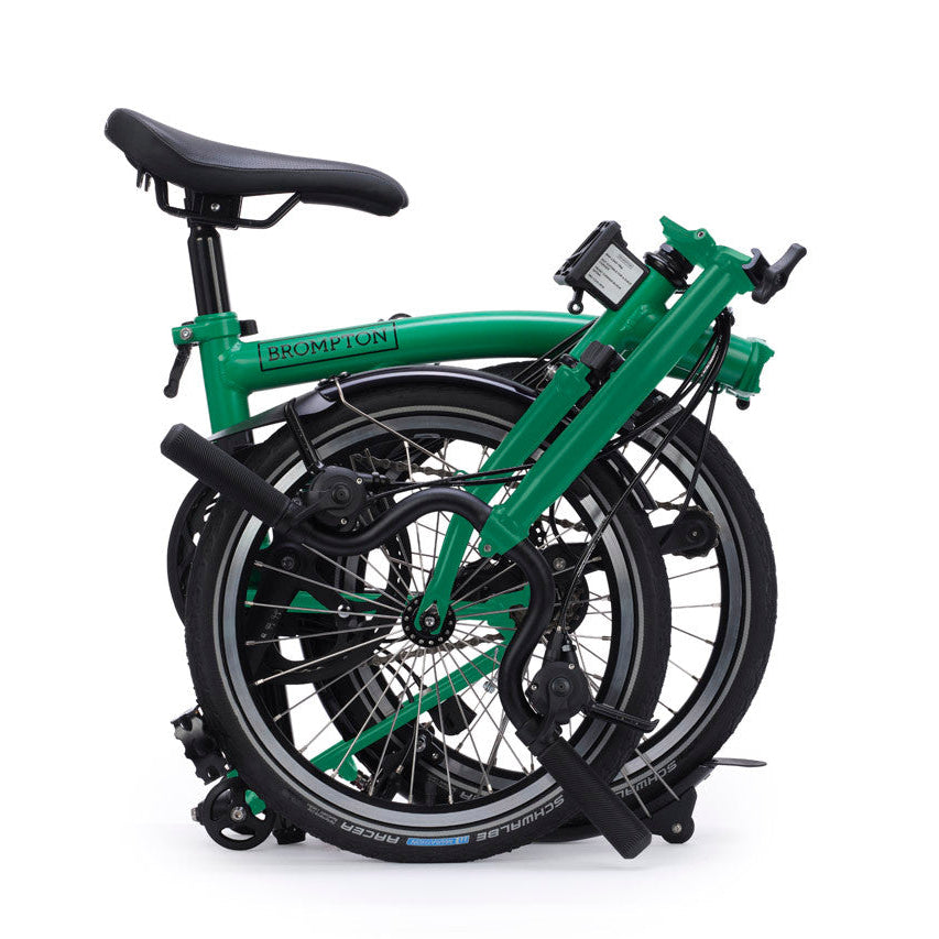 Green folding bicycle on a white background