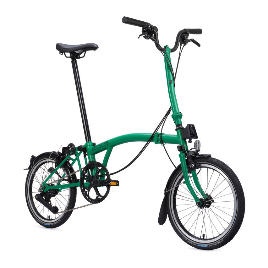 Green folding bicycle on a white background