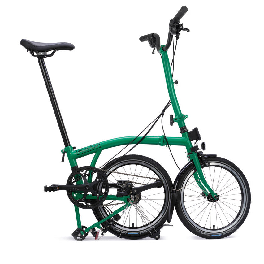 Green folding bicycle on a white background
