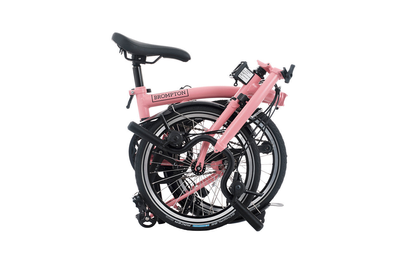 Folded Brompton C line bicycle on the white background.