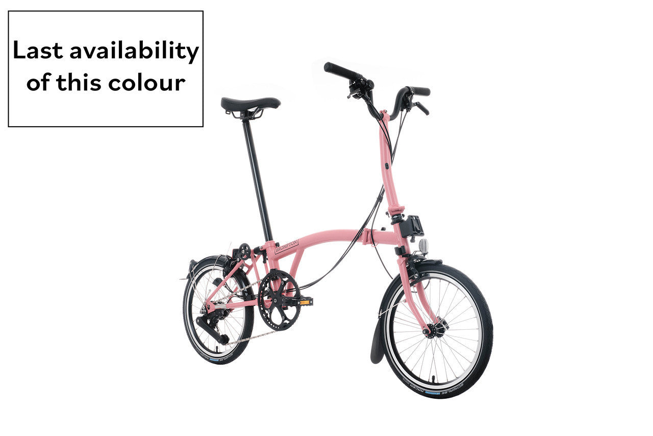 Brompton c Line pink folding bike on white background.