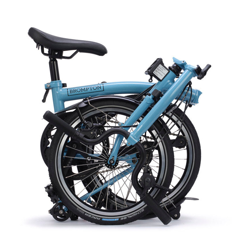 Folded bicycle with a blue frame on a white background