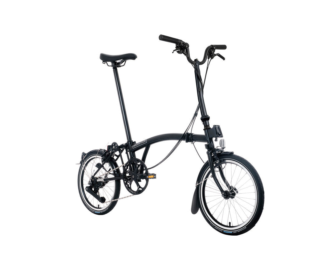 Black Brompton folding bicycle on a white background