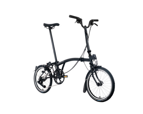 Black Brompton folding bicycle on a white background