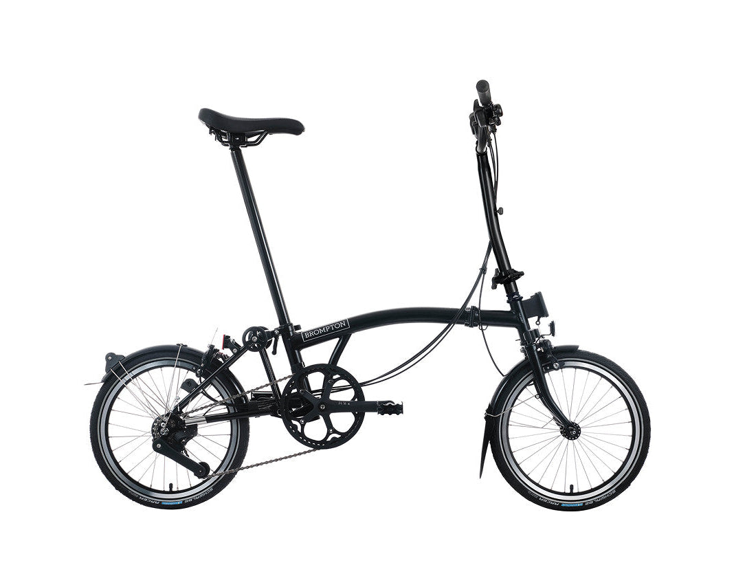 Black Brompton folding bicycle on a white background