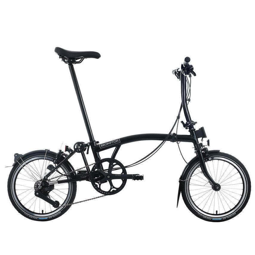 Black Brompton folding bike on a white background