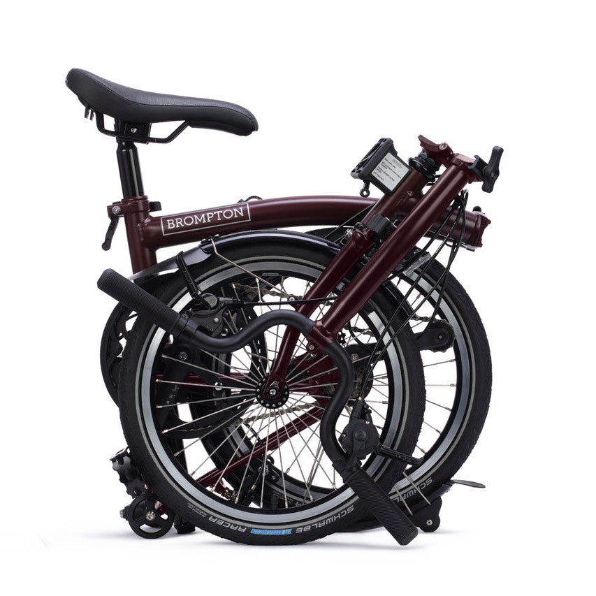 Folded bicycle with 'Brompton' branding on a white background