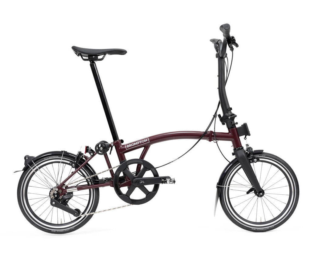 Purple brompton p line folding bicycle on a white background