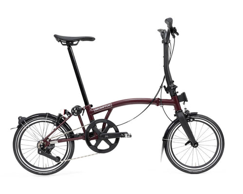 Purple brompton p line folding bicycle on a white background